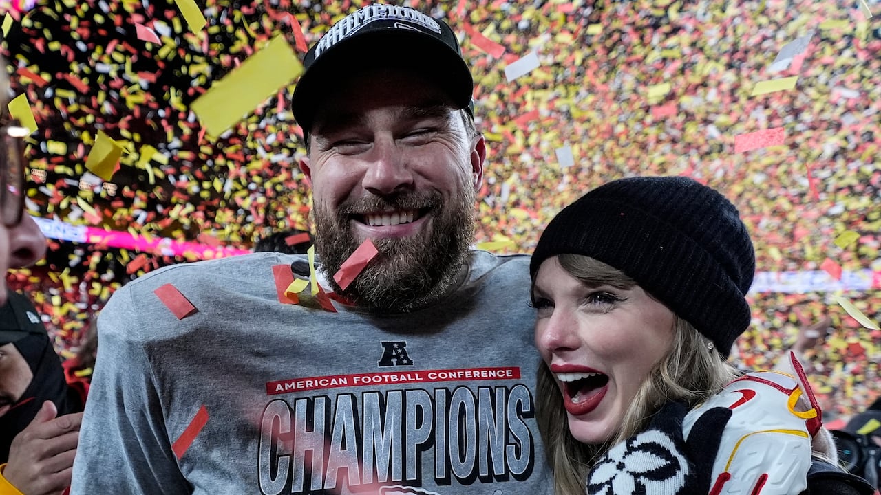 A man and woman embrace underneath confetti.