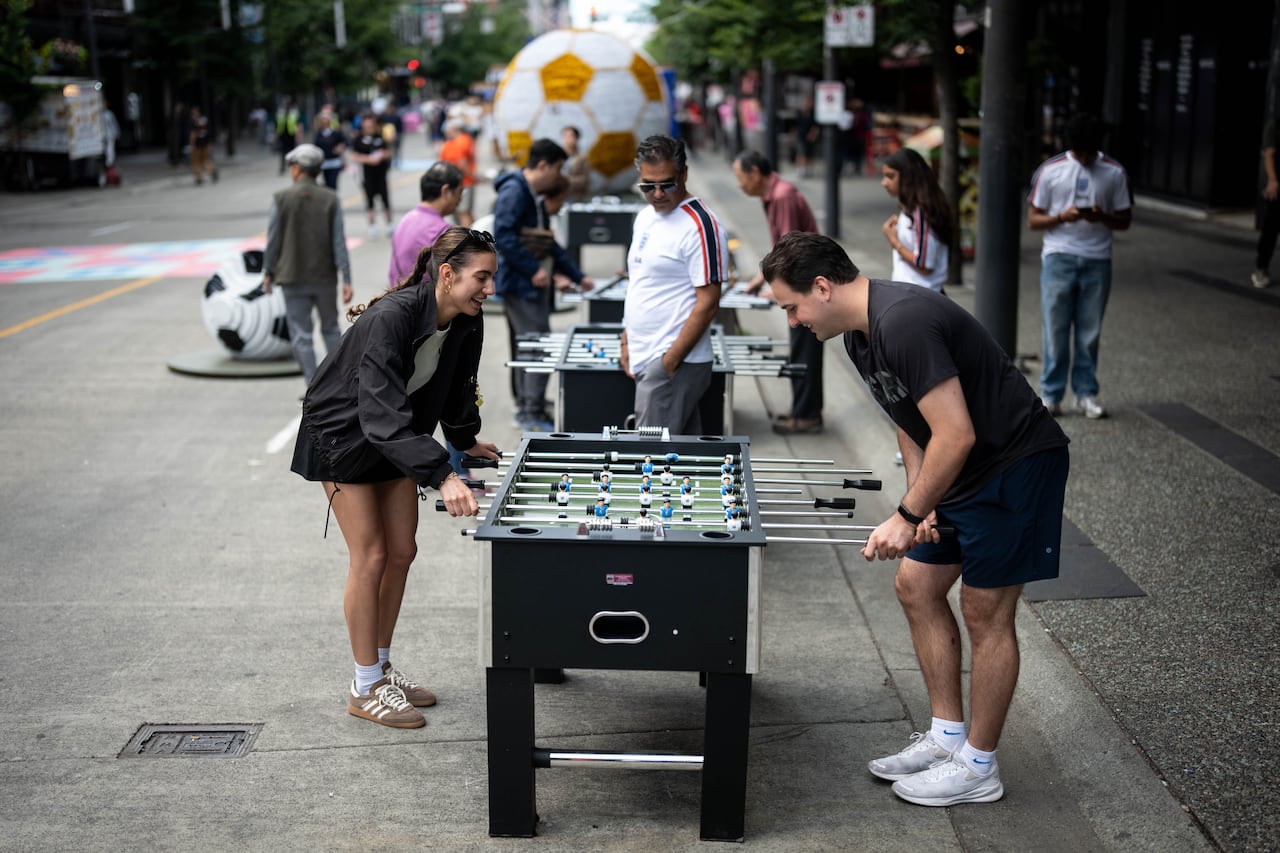 People play foosball on a pedestrianized Granville Street