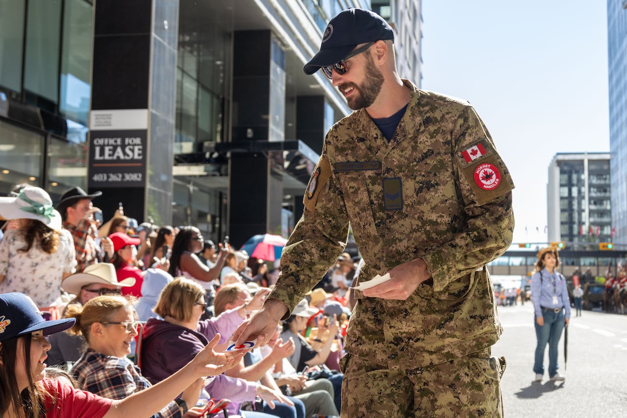 A man hands out gifts to a crowd.