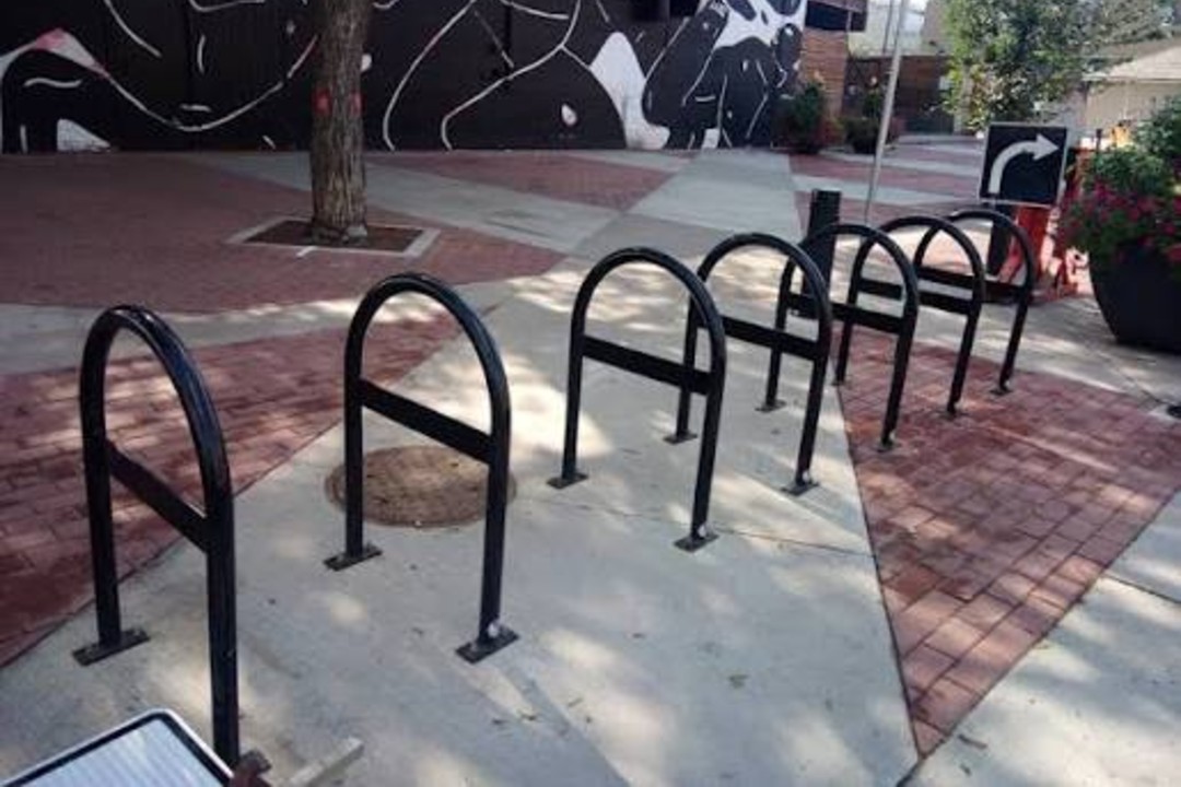 Seven horizontal bike parking spots on a sidewalk