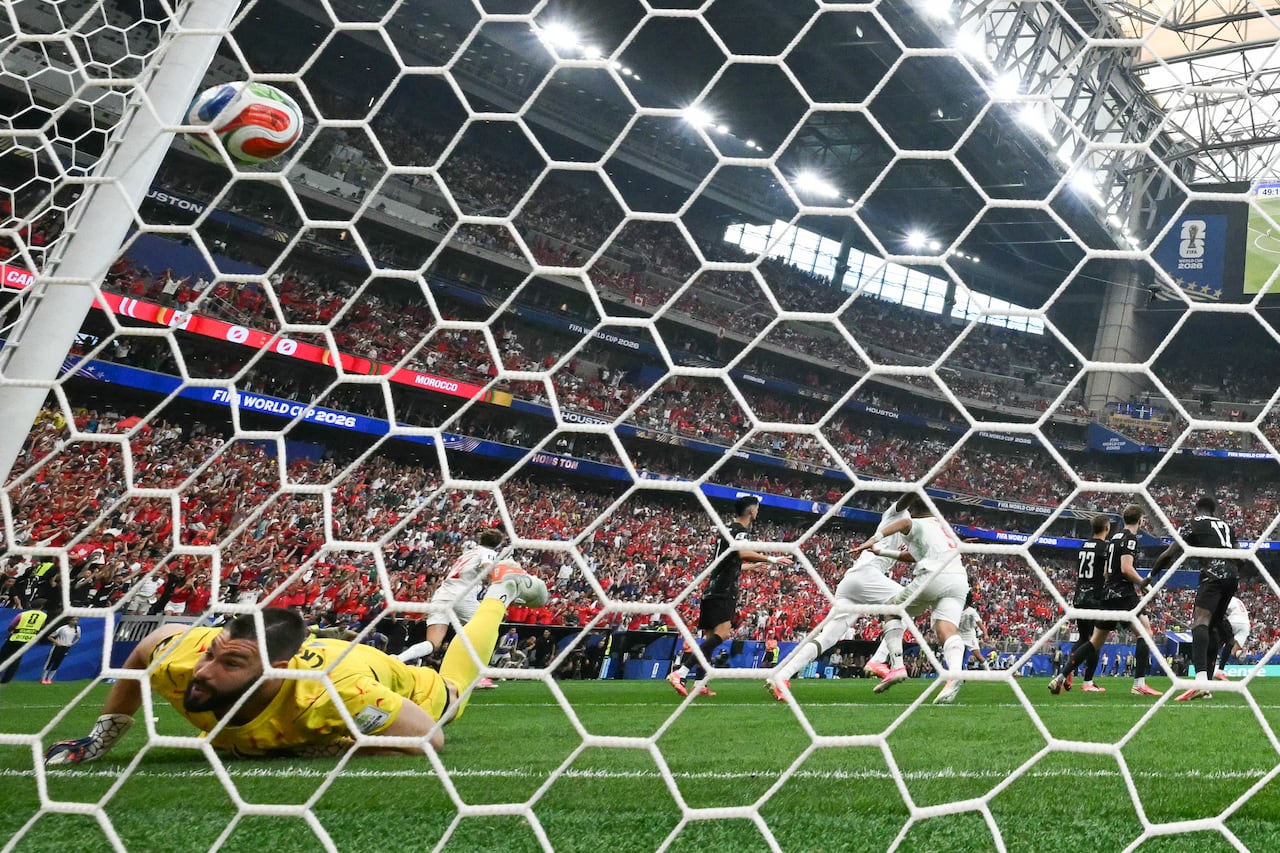 A soccer goalie tries to make a save.