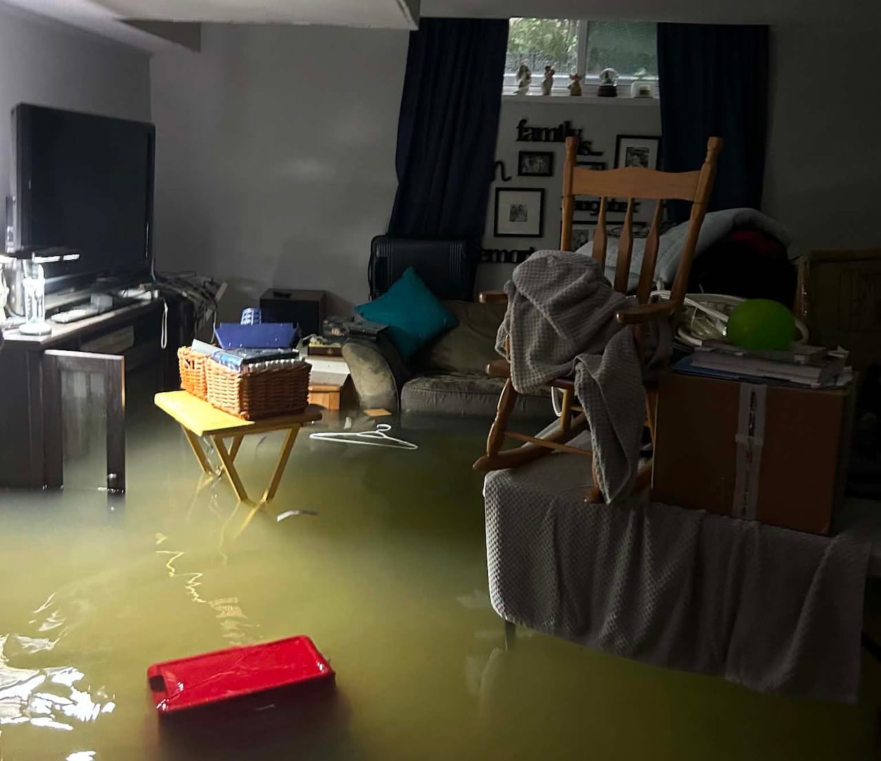 A flooded basement is seen during the day