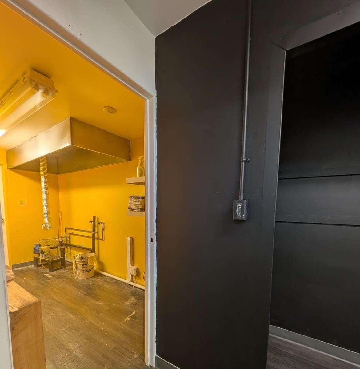 a yellow room and a black room in a basement