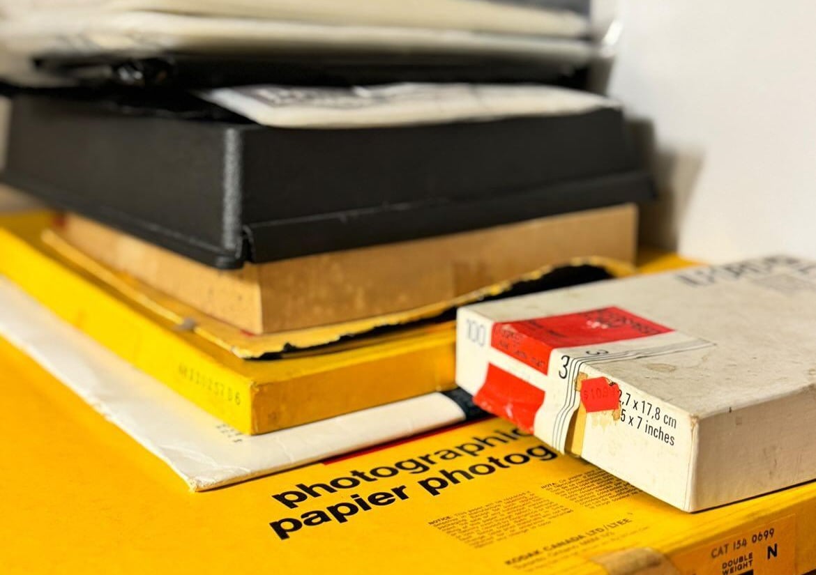 A stack of papers - on the bottom is a yellow box reading "Photographic paper"