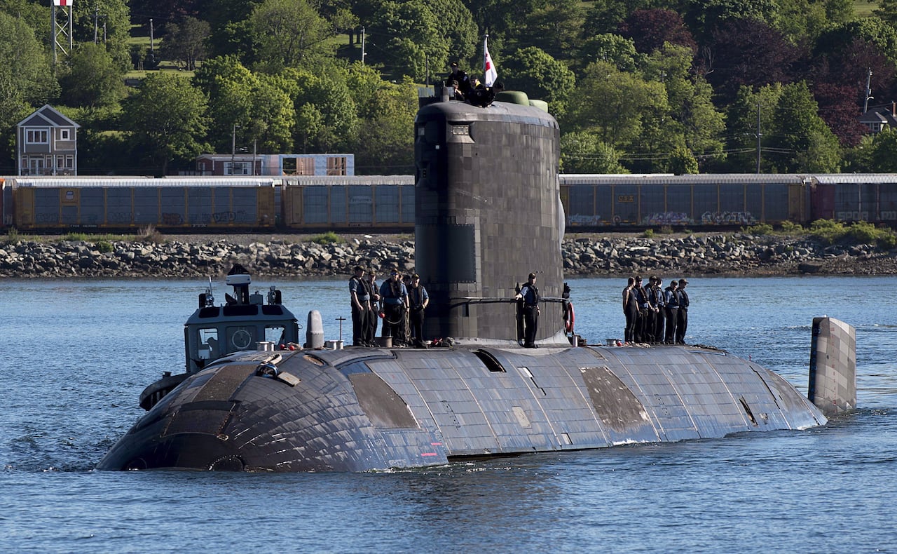 A submarine returns to port.