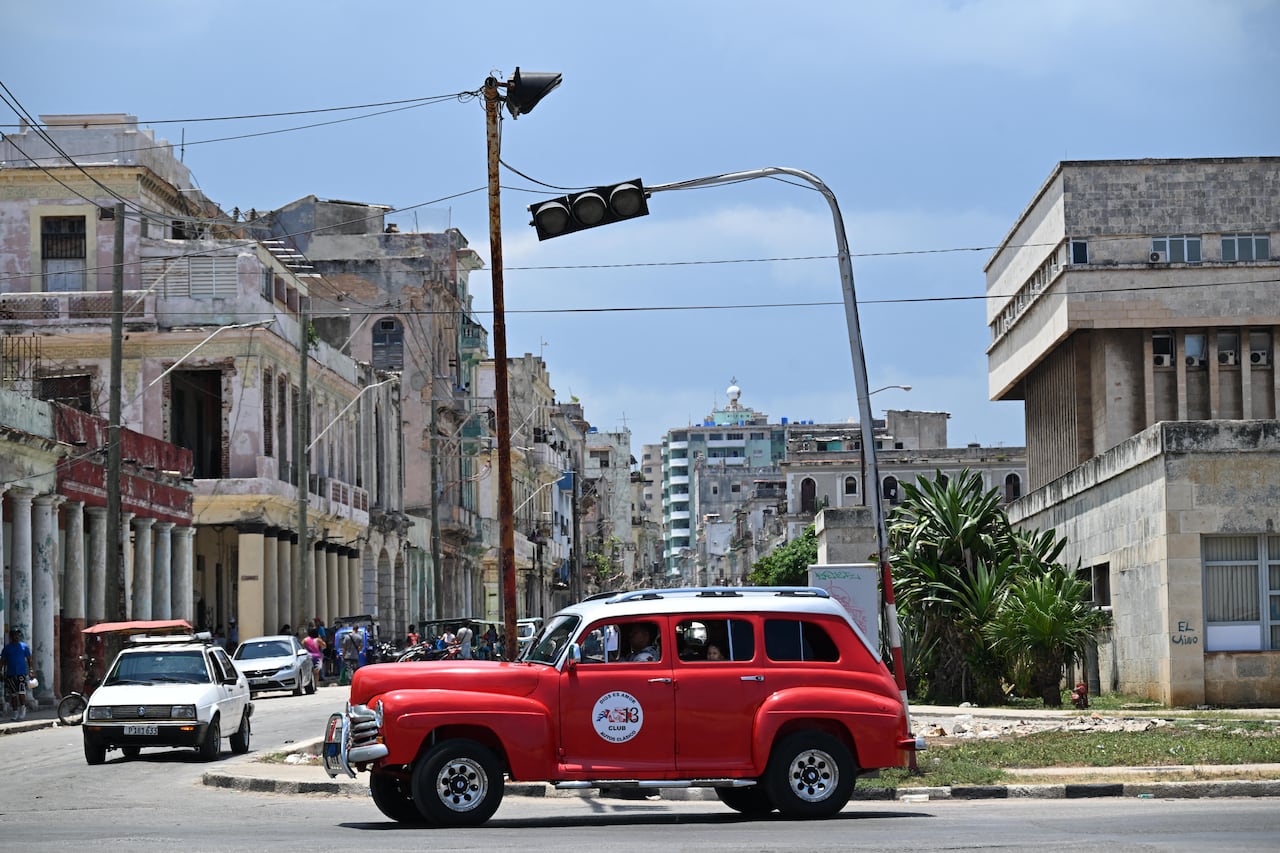 Cars are seen driving in Havana, without the aid of traffic lights, amid a nation-wide power outage.