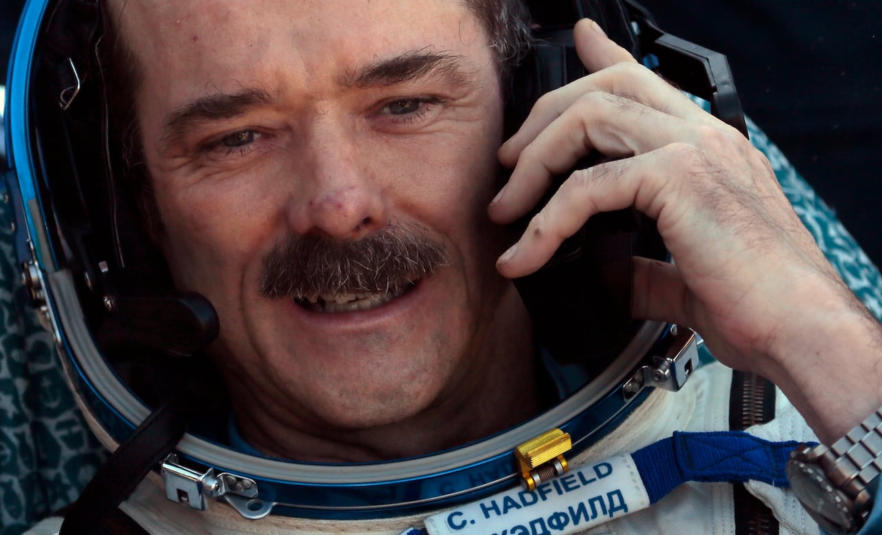 Canadian astronaut Chris Hadfield speaking on a cellphone after landing in the Kazakh town of Dzhezkazgan in May 2013.