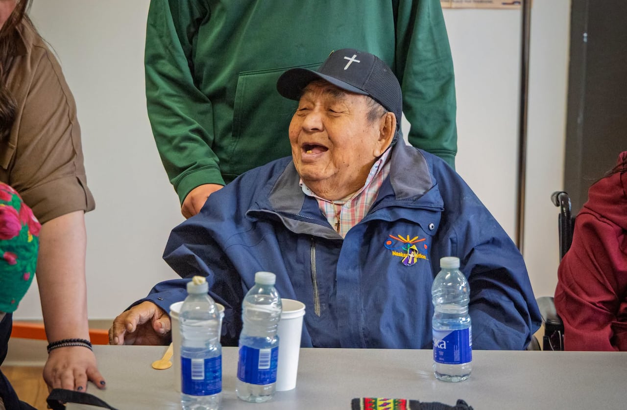 An elderly man smiles