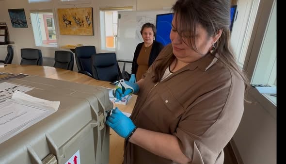 A woman opening a box
