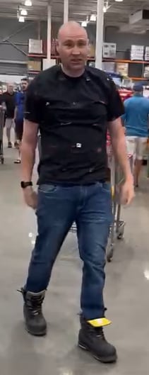Man in black t-shirt, jeans and boots