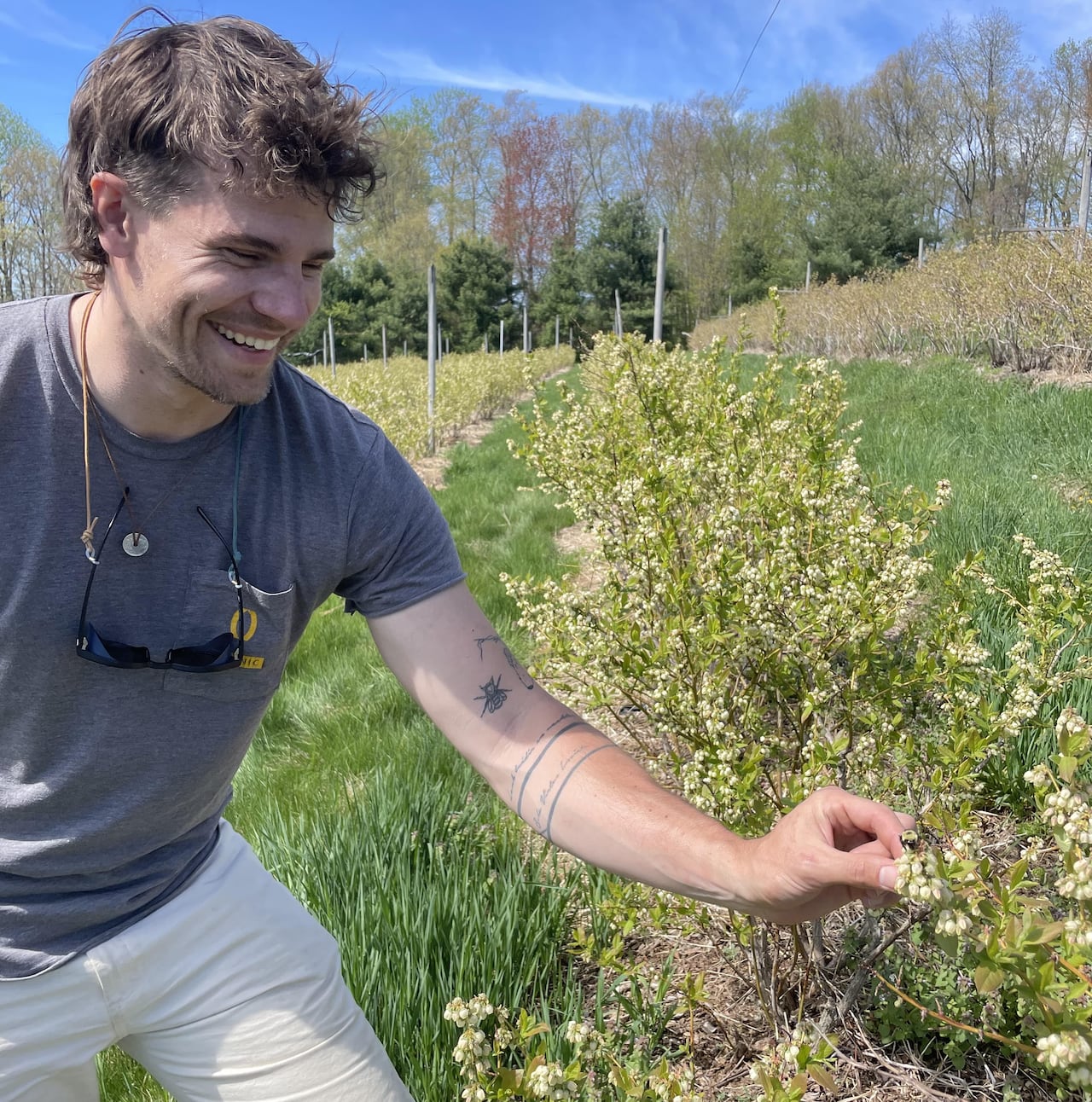 A man outside looking down at a bee.