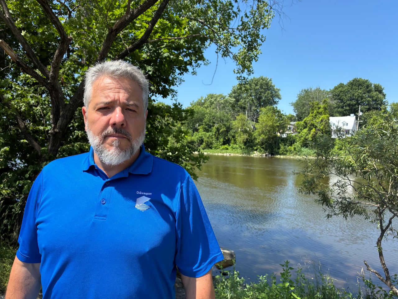 Chateauguay mayor Éric Allard stands in front of the Chateauguay river