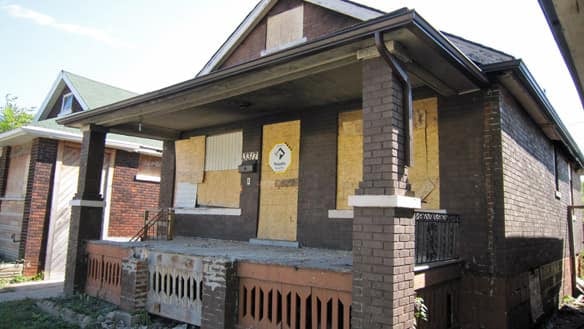A boarded-up vacant home