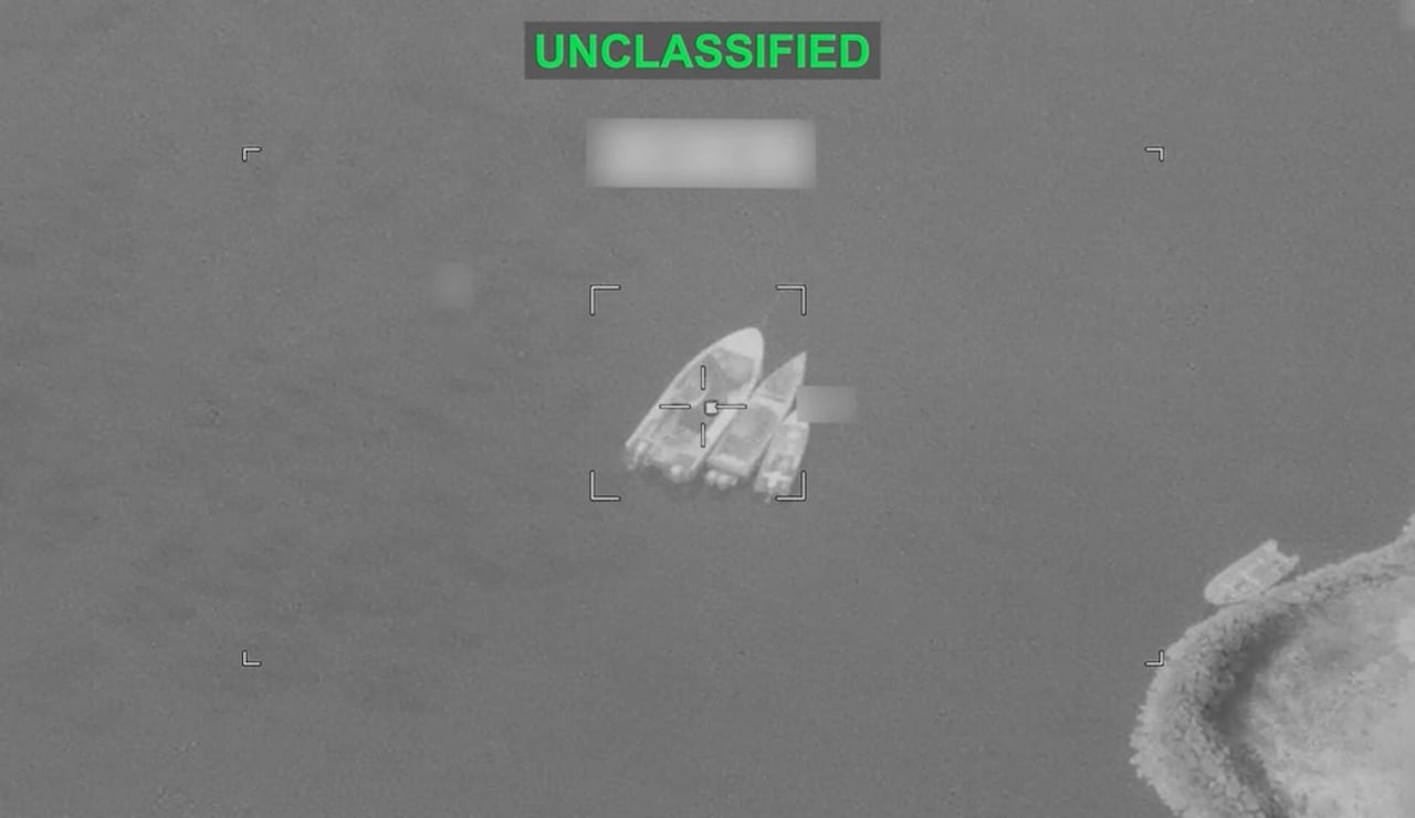 Three boats are pictured in the water in an aerial black and white photo.