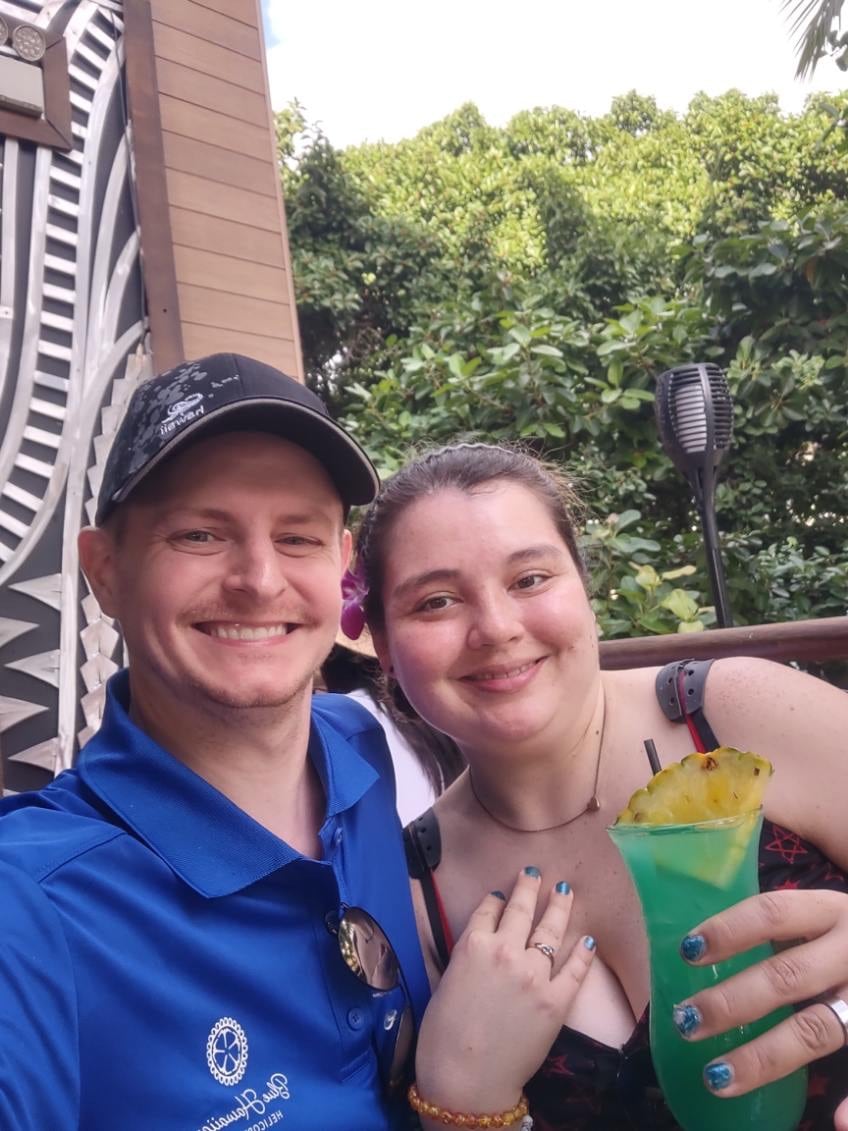A man and woman pose for a selfie together, smiling.