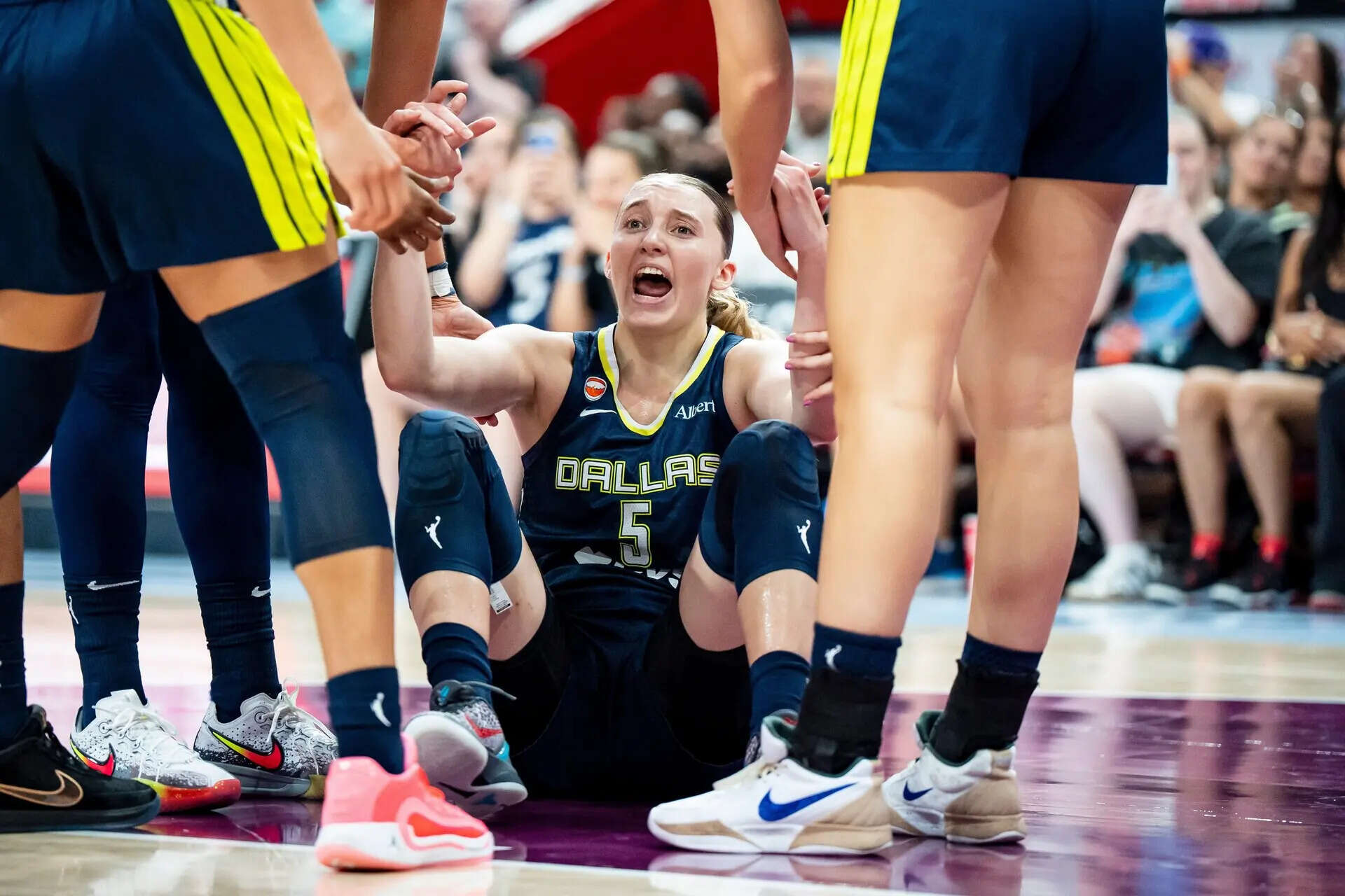 Dallas Wings' Paige Bueckers (5) reacts after drawing a foul during the second half of a WNBA basketball game against the Toronto Tempo in Montreal, Friday, July 10, 2026. (Christopher Katsarov/The Canadian Press via AP) Wings Tempo Basketball