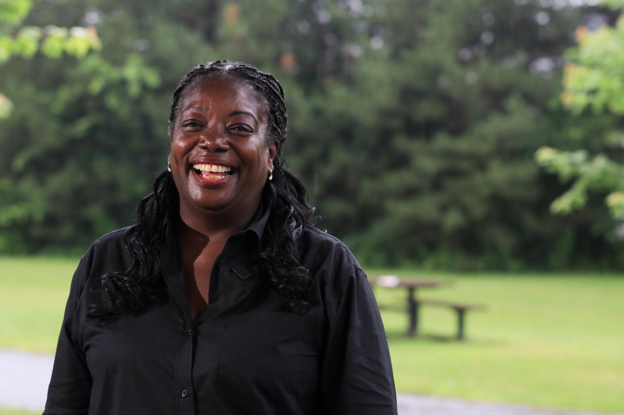 A woman smiling in a park