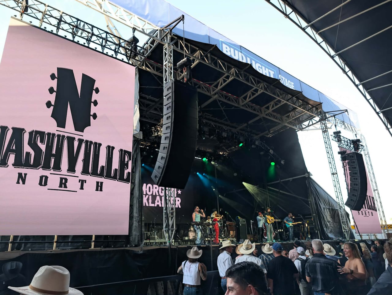 A band performs on a large concert stage with a sign that reads Nashville North