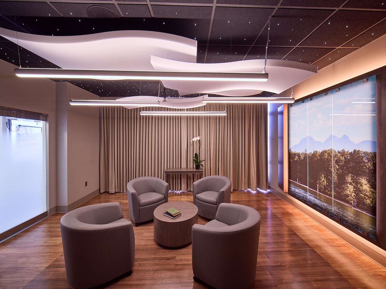 A room with wooden floors and images of a riverside