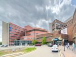 Edmonton, Alberta, Canada. Jun 12, 2025. A grand long shot of the University of Alberta Hospital, a large brick-and-glass medical complex, under a dramatic cloudy sky.