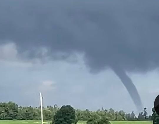 A tornado can be seen in the distance