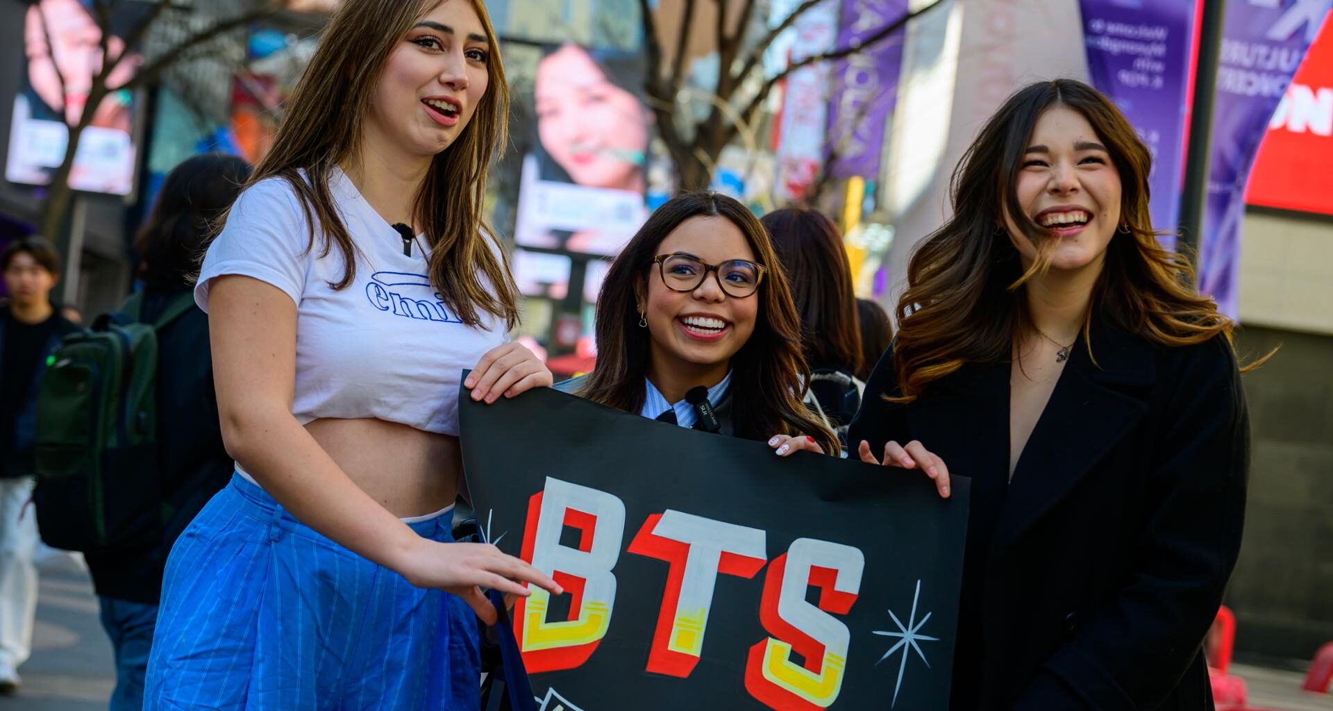 From left, Mexican content creators and BTS fans Fer Vega, Susy Mouriz and Nataly Pop pose for a photo in Myeong-dong, Jung District, Seoul, March 19, two days before the group