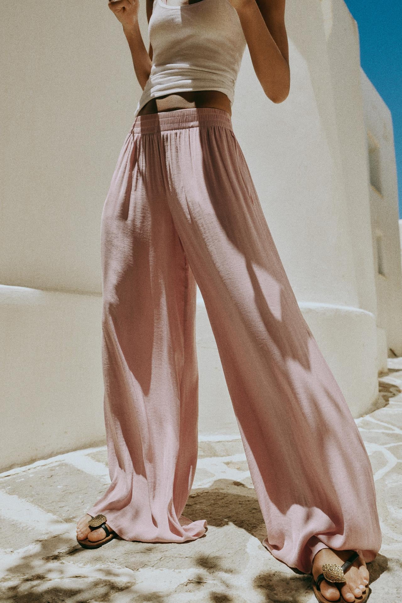 A model in pink, flowy pants