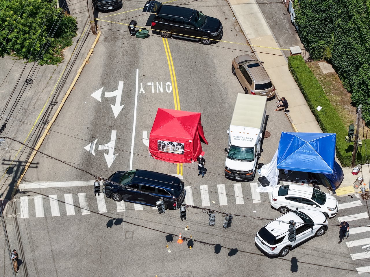 A bird's-eye view shows two tents on either side of a white truck.
