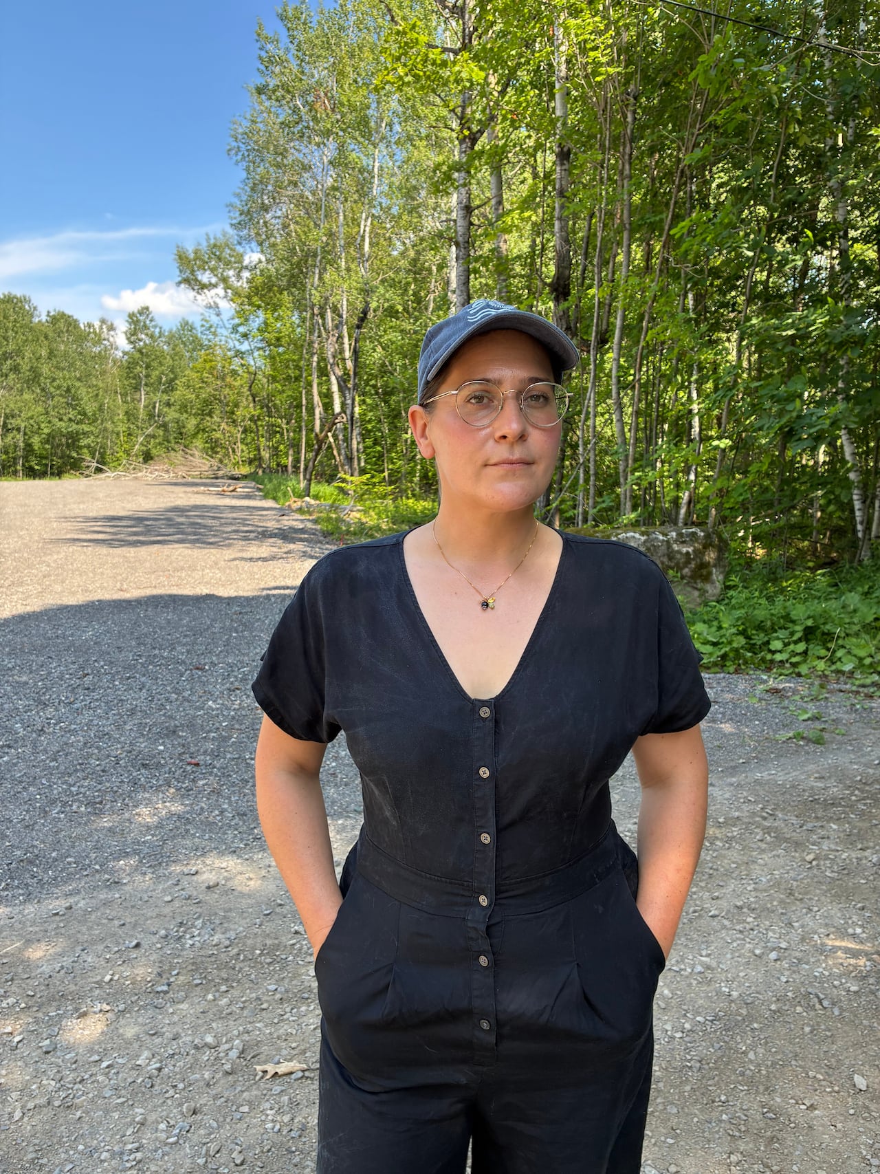 Photo of Bethany Lee standing in front of the site that has been cleared for a second plant.