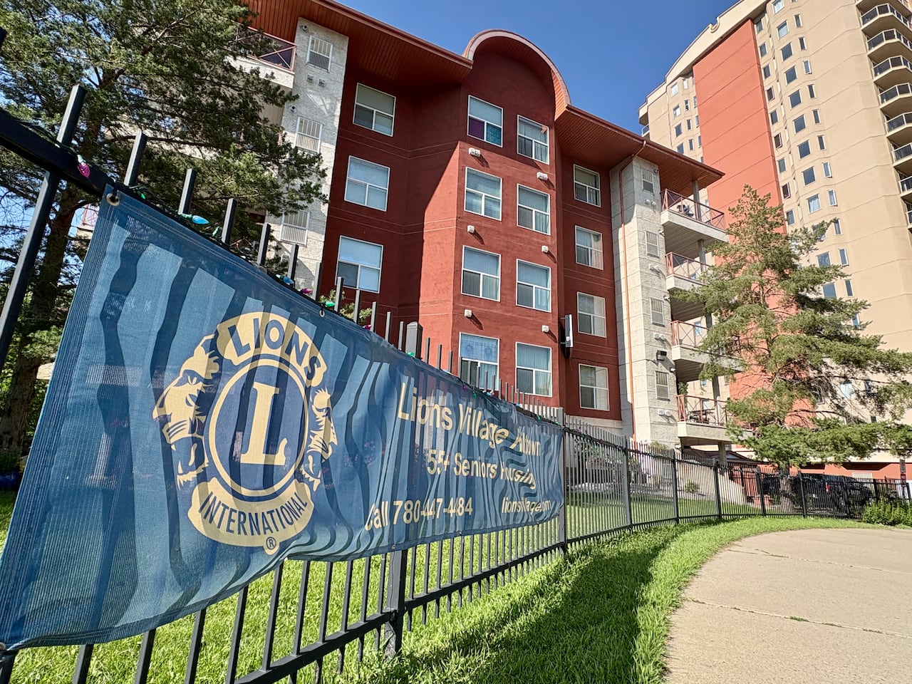 Banner with Lions International with red building behind