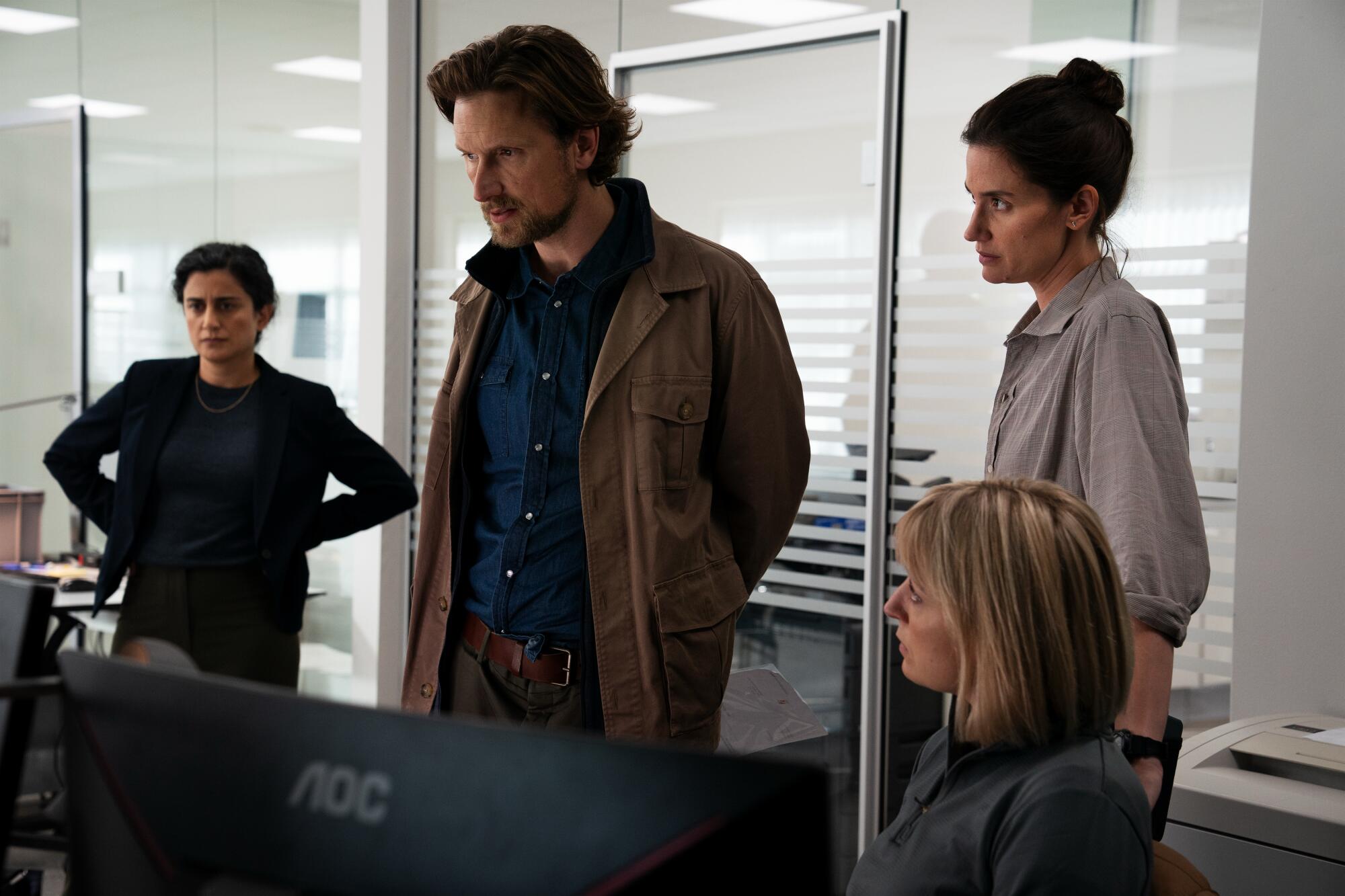 One man and four women look at a computer screen in "The Chestnut Man."