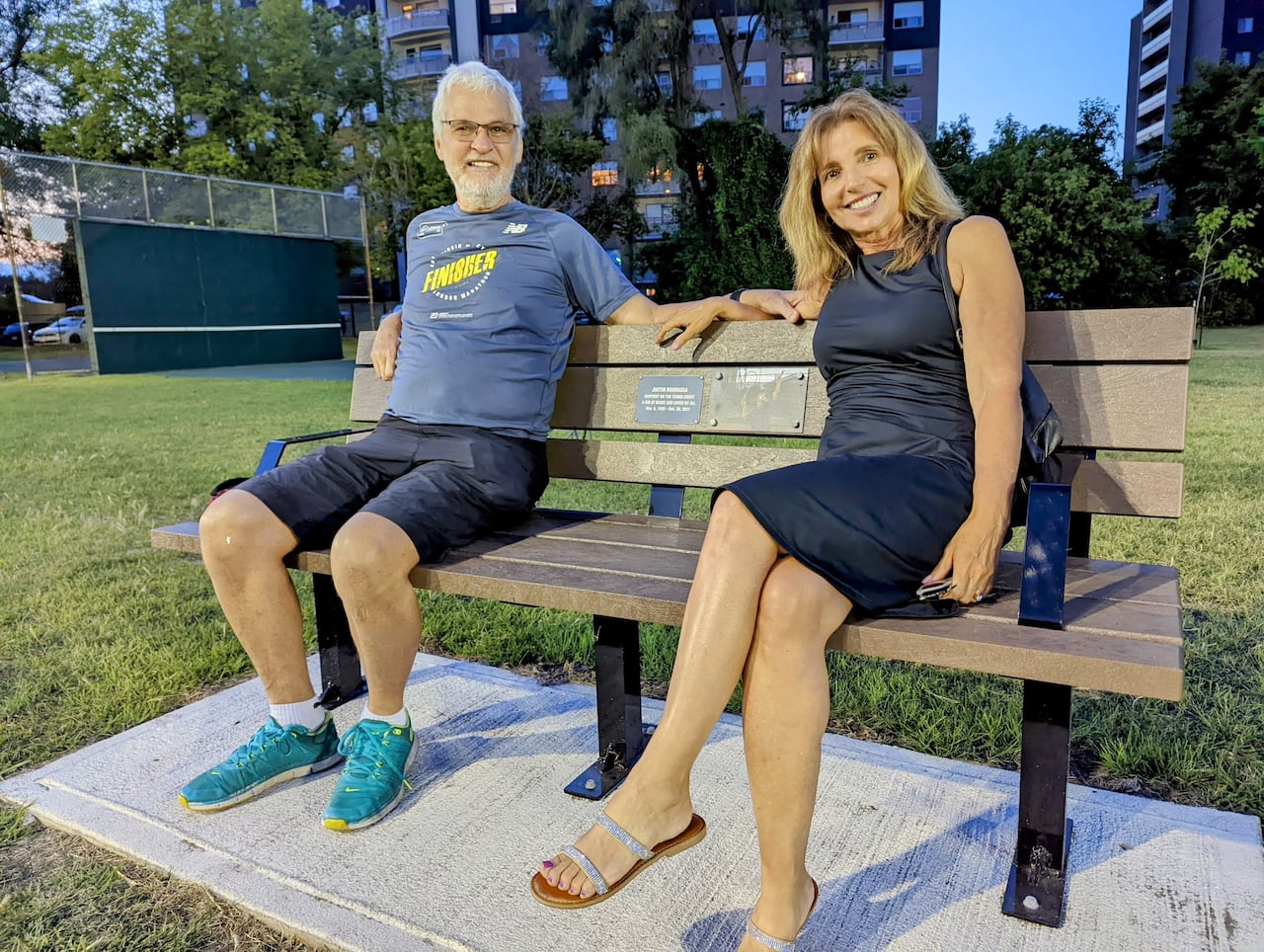 Lorraine Bourassa and her late husband sit on a bench dedicated to their son Justin Bourassa.