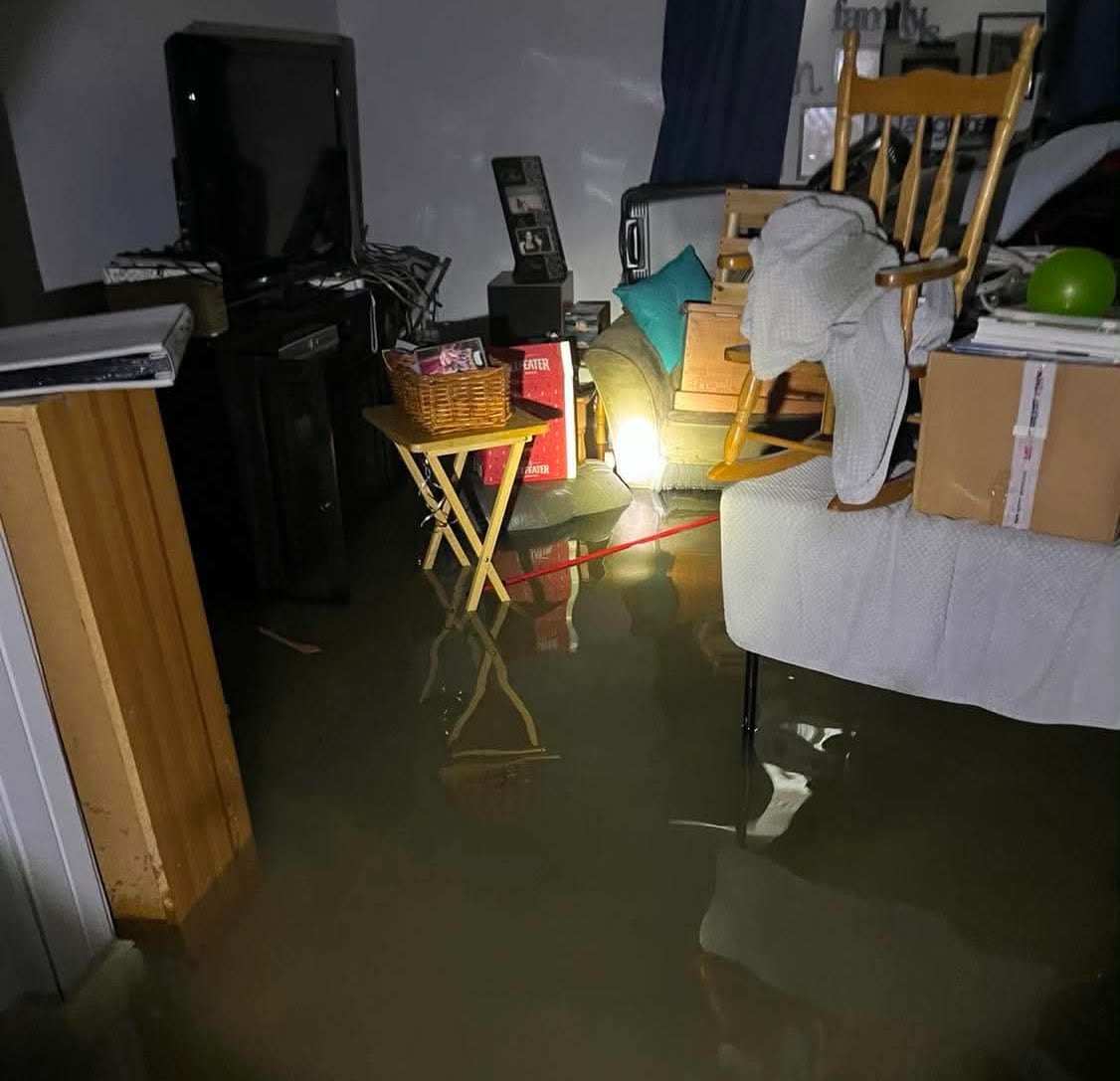 A light illuminates a flooded basement.