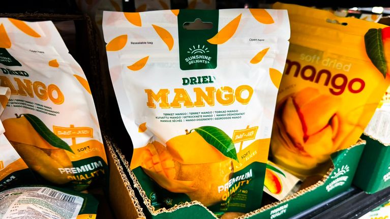 Bags of dried mango on a supermarket shelf.