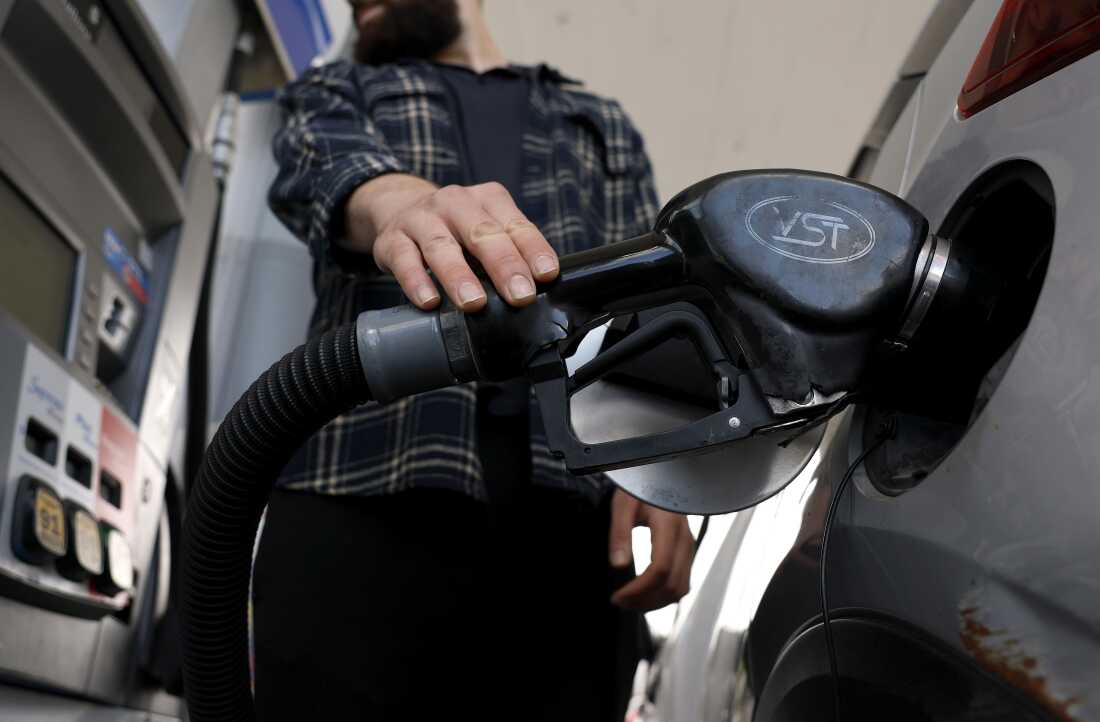 Person filling up a car with gas at a Chevron station