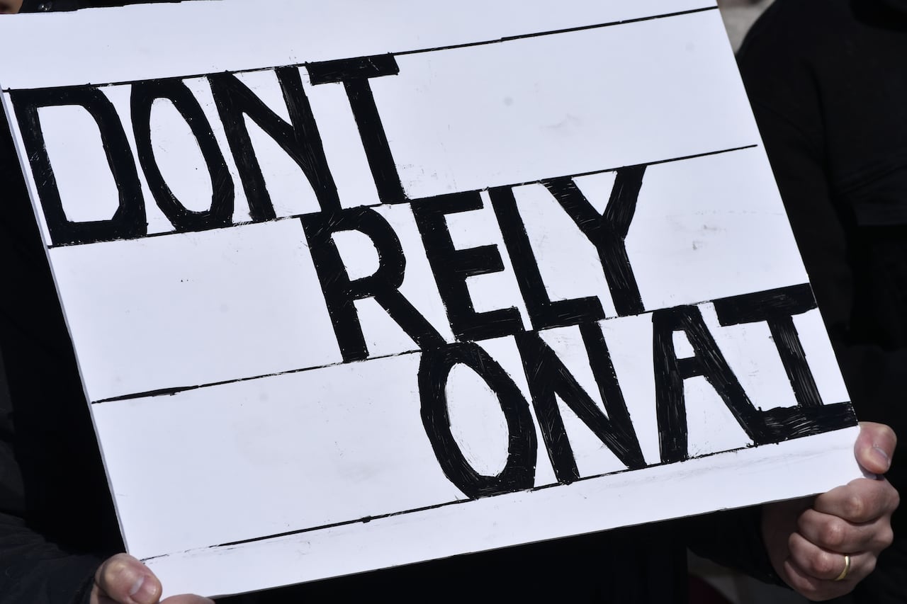 A sign that says, 'DONT RELY ON AI' in black lettering.