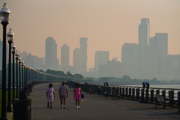The Jersey City skyline is seen through a cover of wildfire smoke, in Jersey City, N.J., Friday, July 17, 2026. (AP Photo/Ryan Murphy)