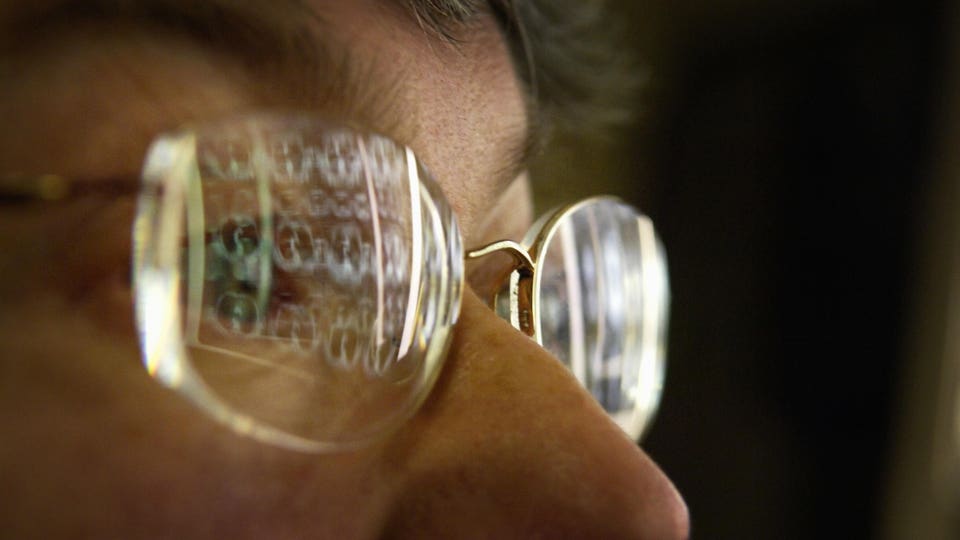 Close-up of CT scan results reflected in glasses of physician