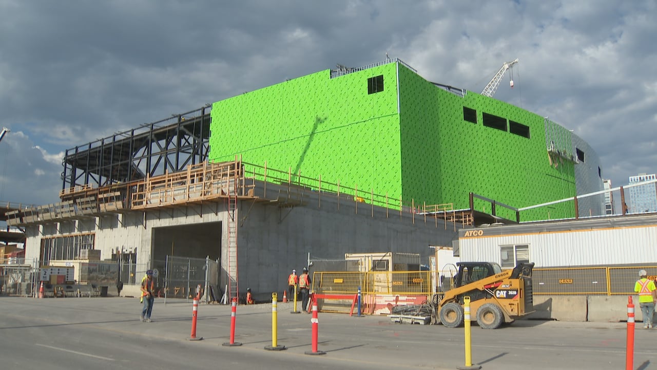 Construction of Scotia Place. It's partially covered in neon green — the lower shell.