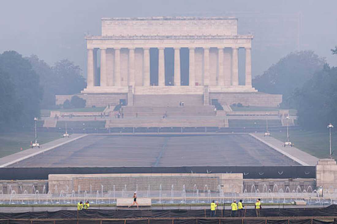 Image shows a colored haze over the Lincoln Memorial in Washington, D.C. on July 17, 2026, caused by smoke from massive wildfires in Canada and Minnesota.