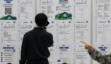 Job seekers look at job postings at a job fair in Seoul, Wednesday. Yonhap