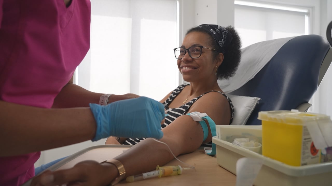 A woman sitting in a chair about to get blood drawn