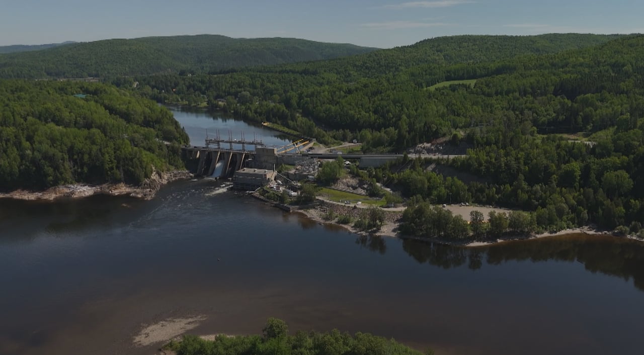 An aerial photo of a large concrete dam on a river.
