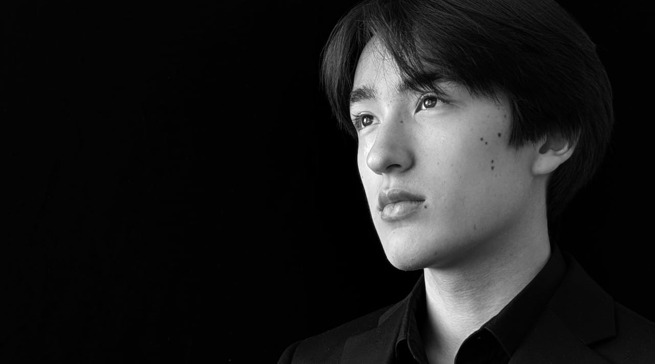 A black and white photo of Forest Benson, who's looking off pensively to the left.