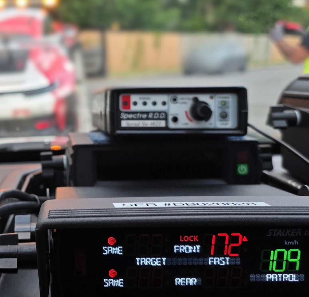 A piece of police radar equipment inside a vehicle shows a speed reading of 172.