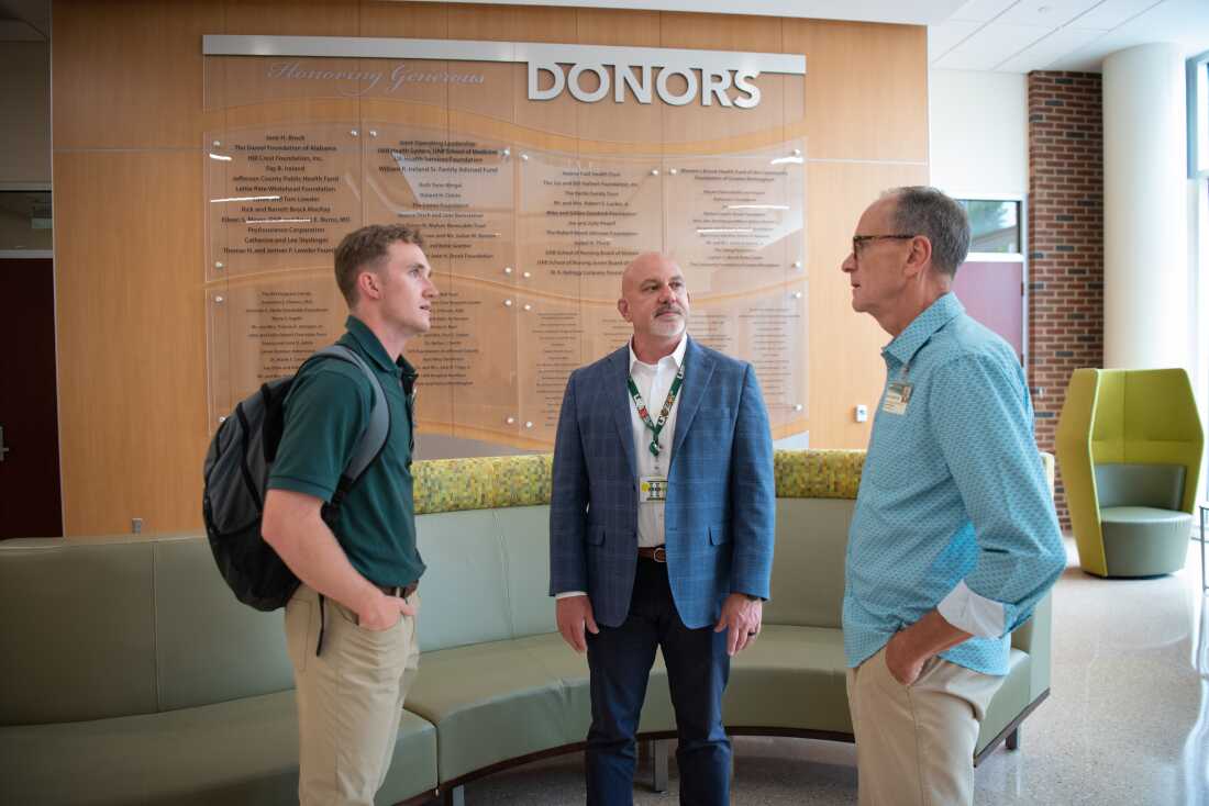 Nursing student Connor Aderholt speaks with professors Curry Bordelon and Gregory Eagerton in the lobby of the University of Alabama at Birmingham School of Nursing.