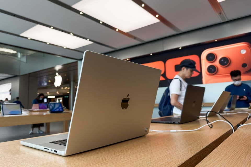 Customers Browse MacBook Laptops at Apple Store in Hong Kong Amid Recent Price Increases