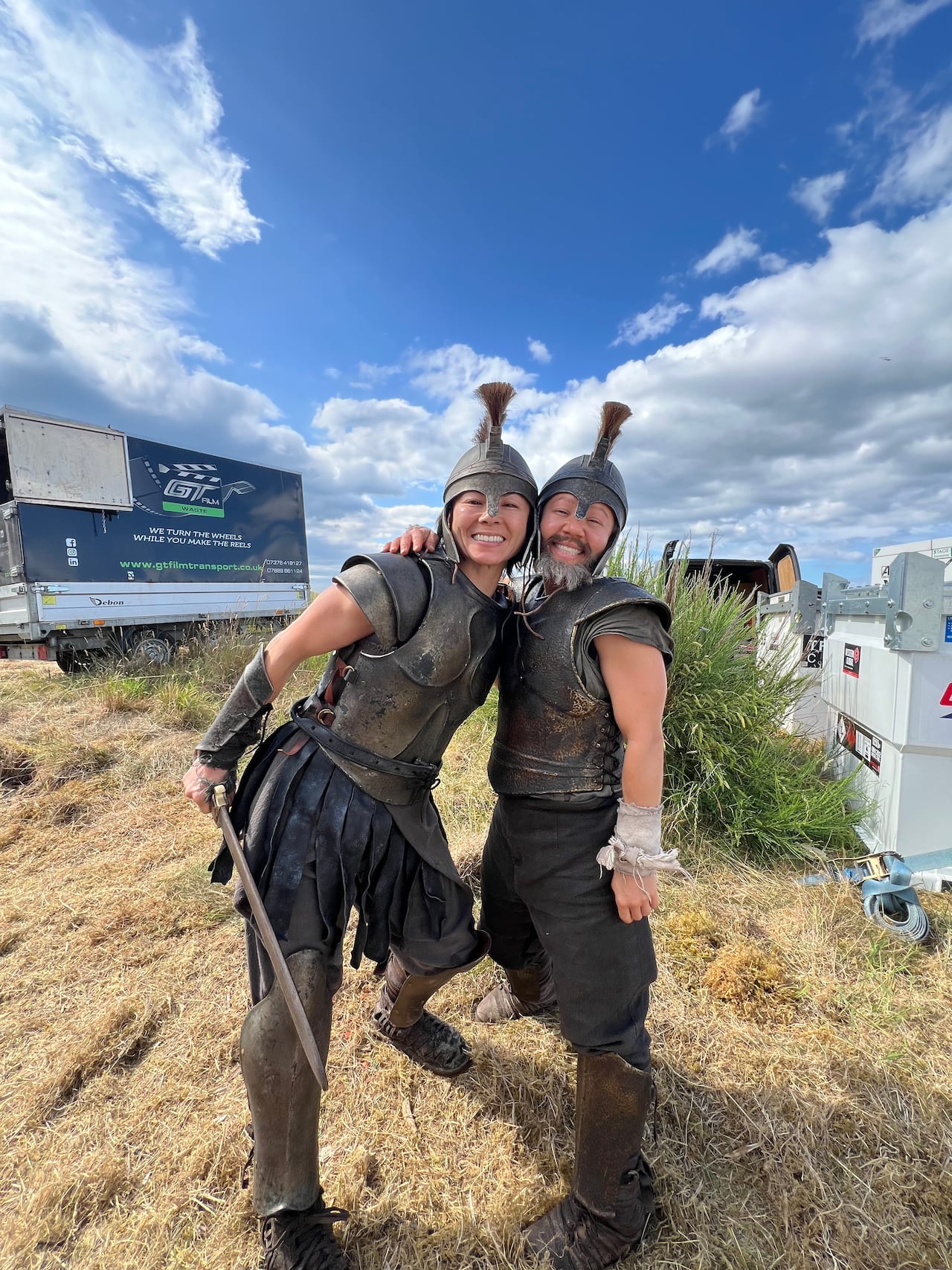 Two women dressed in the armour of Greek warriors.