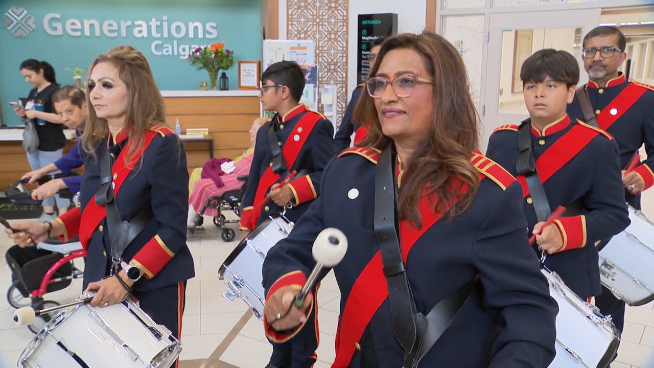 Gulnar Hemani, a drummer in the Calgary Ismaili Pipe Band, marches through the Generations lobby playing a tune.
