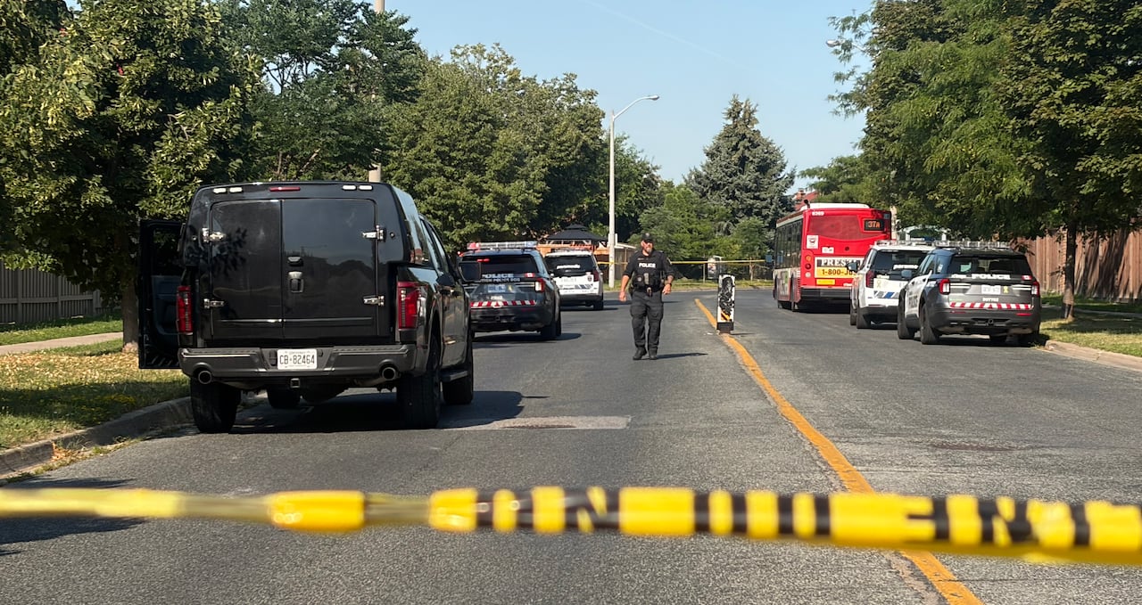 Police officer walking behind taped off area